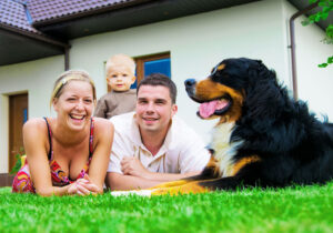 family in grass with dog