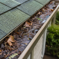 Clogged gutter filled with leaves and debris